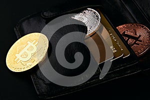 Wallet with golden bitcoins and bank credit cards