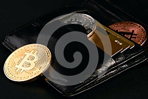 Wallet with golden bitcoins and bank credit cards
