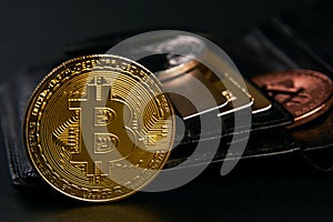 Wallet with golden bitcoins and bank credit cards