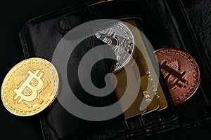 Wallet with golden bitcoins and bank credit cards