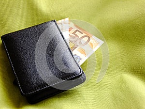 Wallet on greenish Textile Background