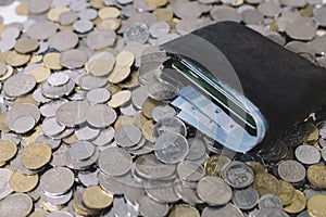 Wallet on a group of coins.