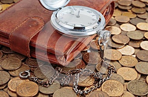 Wallet and pocket watch on the coins