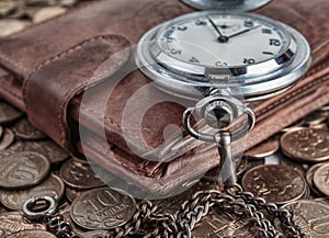 Wallet and pocket watch on the coins