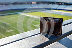 wallet on stadium bleacher with sports field