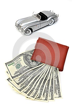 Wallet with US Dollars and blured car background