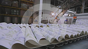 Wallpaper production, wallpaper production process. Movement of wallpaper on the conveyor line. Industrial interior.