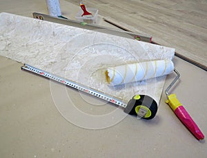 Wallpaper roller, tape measure and level