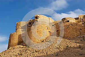 Walls and bastions of the fort with the blue sky above in Jaisalmer, India. photo