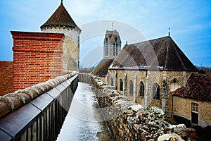 Walls covered with snow on old tower of Blandy-les-Tours castle