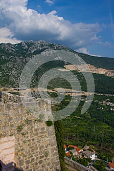 Walls of Klis fortres with a view to Mosor mountain in Croatia