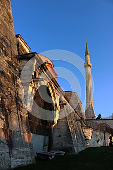 Walls with old wooden gates and the tower of the Hagia Sophia Museum in the center of Istanbul, from Kabasakal Cd.. ÃÂ¢urkey