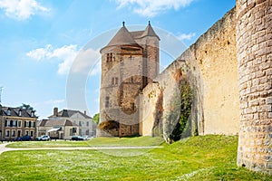 Walls and towers of Blandy-les-Tours castle from the village