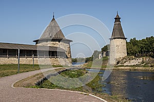 The walls and towers of Pskov Kremlin on the banks of the river