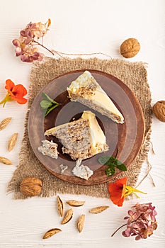 Walnut and almond cake on white wooden, top view