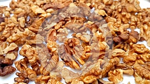 Walnut close up without the shell. Looped spinning walnut. Walnut kernels rotating. Full frame background