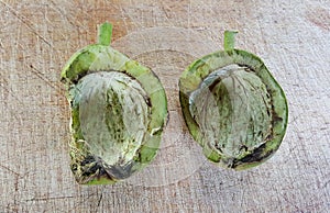 walnut husk on a scratched wood background