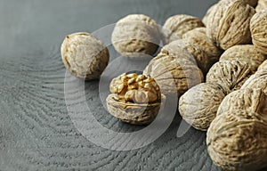 Walnut kernel with shell on wooden backdrop. healthy food for brain. walnut background