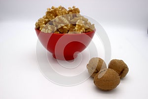 Walnut Kernels In Red Bowl Other Names: Juglans Regia, Persian Walnut, English Walnut, Circassian Walnut. Isolated Image On A