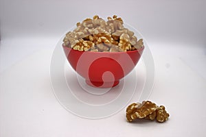 Walnut Kernels In Red Bowl Other Names: Juglans Regia, Persian Walnut, English Walnut, Circassian Walnut. Isolated Image On A