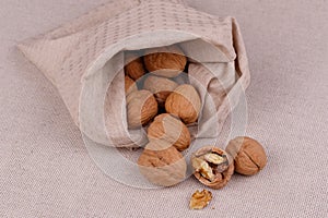 walnuts in a bag on a fabric background