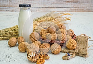 Walnut kernels and whole walnuts on rustic old wooden table