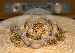 Walnut kernels and whole walnuts wood background