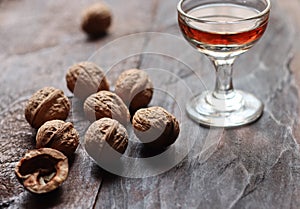 Walnut liquor in glass and walnuts