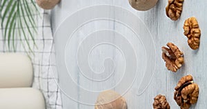 Walnut milk, female hand taking a glass of non-dairy drink made of walnuts, kitchen table on background, close-up video