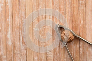 Crack the Nut Walnut and nutcracker on bamboo background