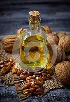 Walnut oil in bottle and nuts