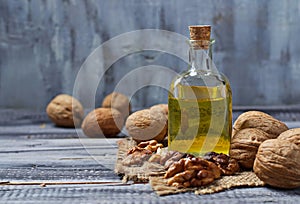 Walnut oil in bottle and nuts