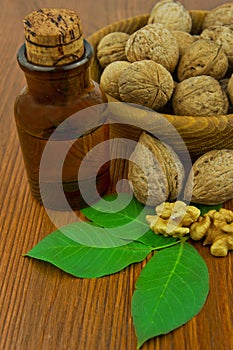 Walnut oil and nuts on wooden table