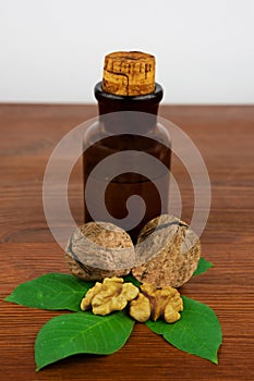 Walnut oil and nuts on wooden table