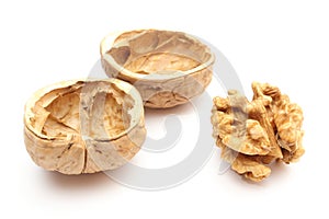 Walnut without shell and nutshells on white background