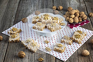 Walnut squares pastry on white ceramic tray