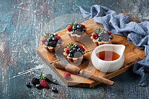 Walnut tartlets with custard and berries