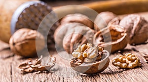 Walnut. Walnut kernels and whole walnuts on rustic old oak table