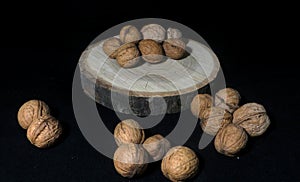 Walnut and walnuts on the black background