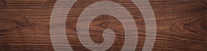 Walnut wood texture.  Natural texture background of North American walnut wood board.  Long wood plank texture. photo