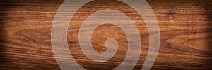 Walnut wood texture.  Natural texture background of North American walnut wood board.  Long wood plank texture. photo
