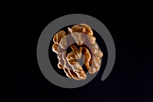 Walnuts on a black brown background.