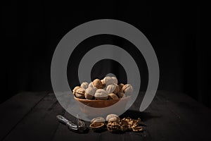 Walnuts in a bowl on dark background