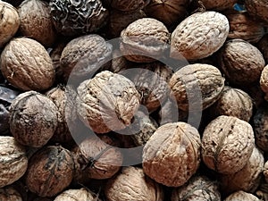 Walnuts close-up. Harvest of nuts. Walnut fruits, rounded large single single-seeded drupes. A healthy diet that includes