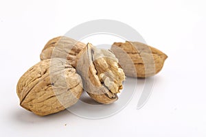 Walnuts and cracked walnut, isolated on white background