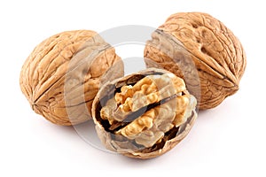 Walnuts and cracked walnut on white background