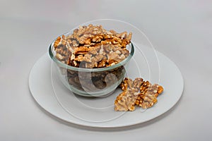 walnuts in the cup of glass bowl, rosted walnuts with white background with glass bowl