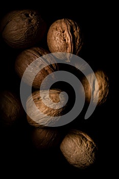 Walnuts on dark background with shadows