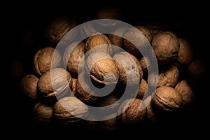 Walnuts on dark background with shadows