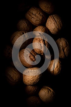 Walnuts on dark background with shadows